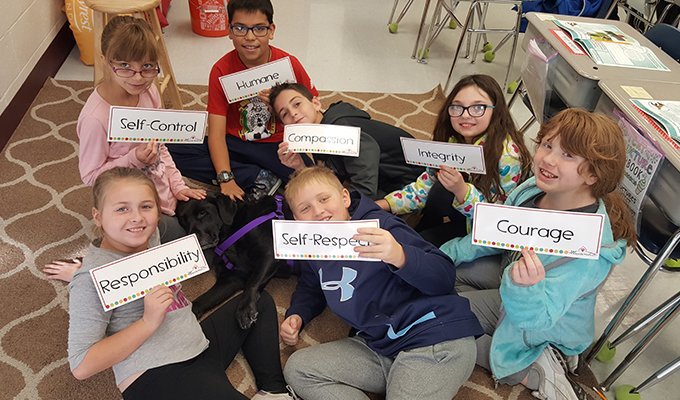 Students participating in the tails with tales reading program